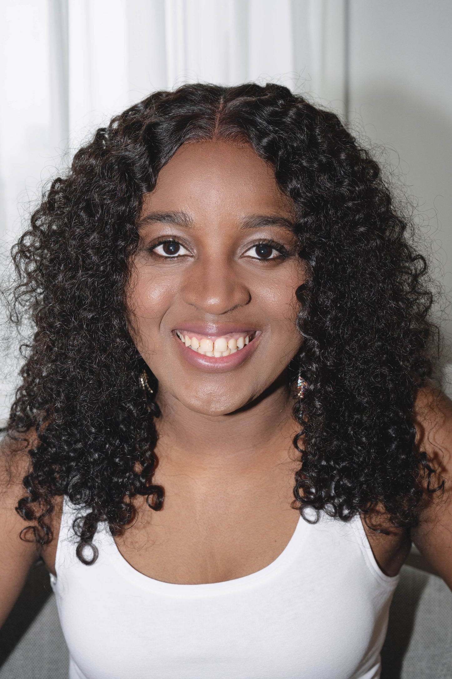 Adora wig featuring vibrant, kinky curly texture made from 100% human hair, offering a voluminous and natural look with bouncy curls. Available in a variety of shades for a personalized style.