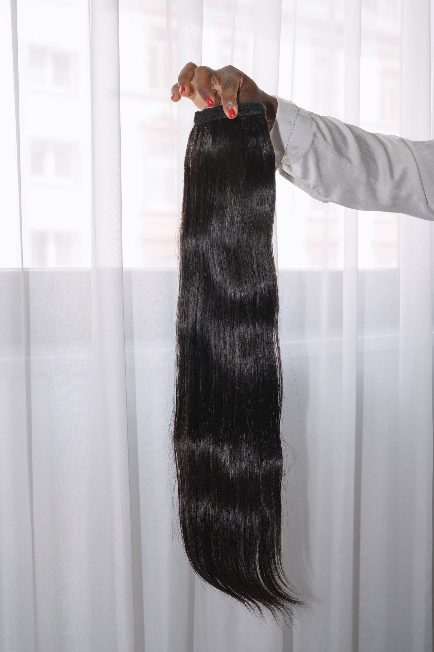 22-inch Bone Straight ponytail made of 100% raw human hair in natural black (Color 1B), sleek and silky texture, 100g