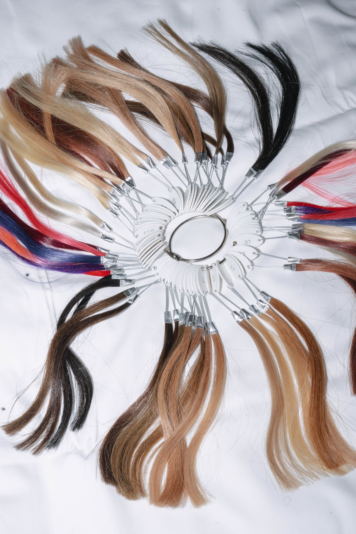 Color ring showcasing vibrant hair extensions made from 100% human hair sourced from Vietnam, offering a variety of shades for customizable styles