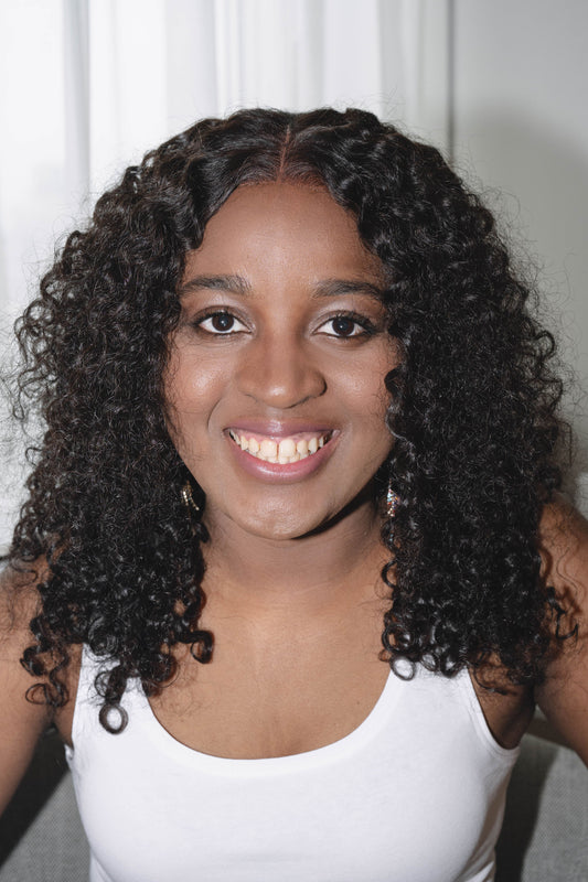Adora wig featuring vibrant, kinky curly texture made from 100% human hair, offering a voluminous and natural look with bouncy curls. Available in a variety of shades for a personalized style.