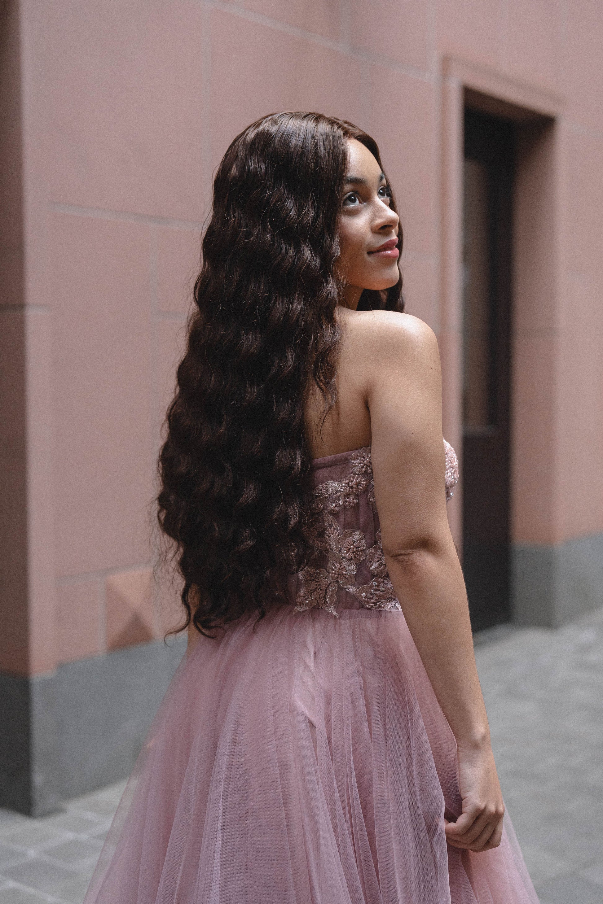 Woman wearing Célia wig made from 100% human hair, designed for a sleek, elegant look with a natural appearance and smooth texture. Available in multiple colors for a customized style.