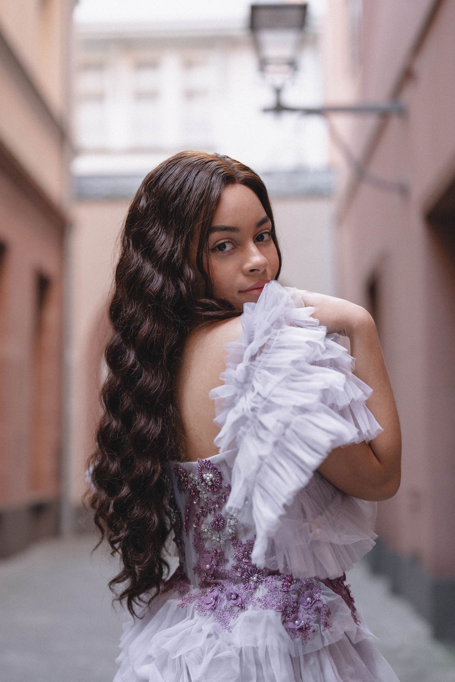 Woman wearing Célia wig made from 100% human hair, designed for a sleek, elegant look with a natural appearance and smooth texture. Available in multiple colors for a customized style.