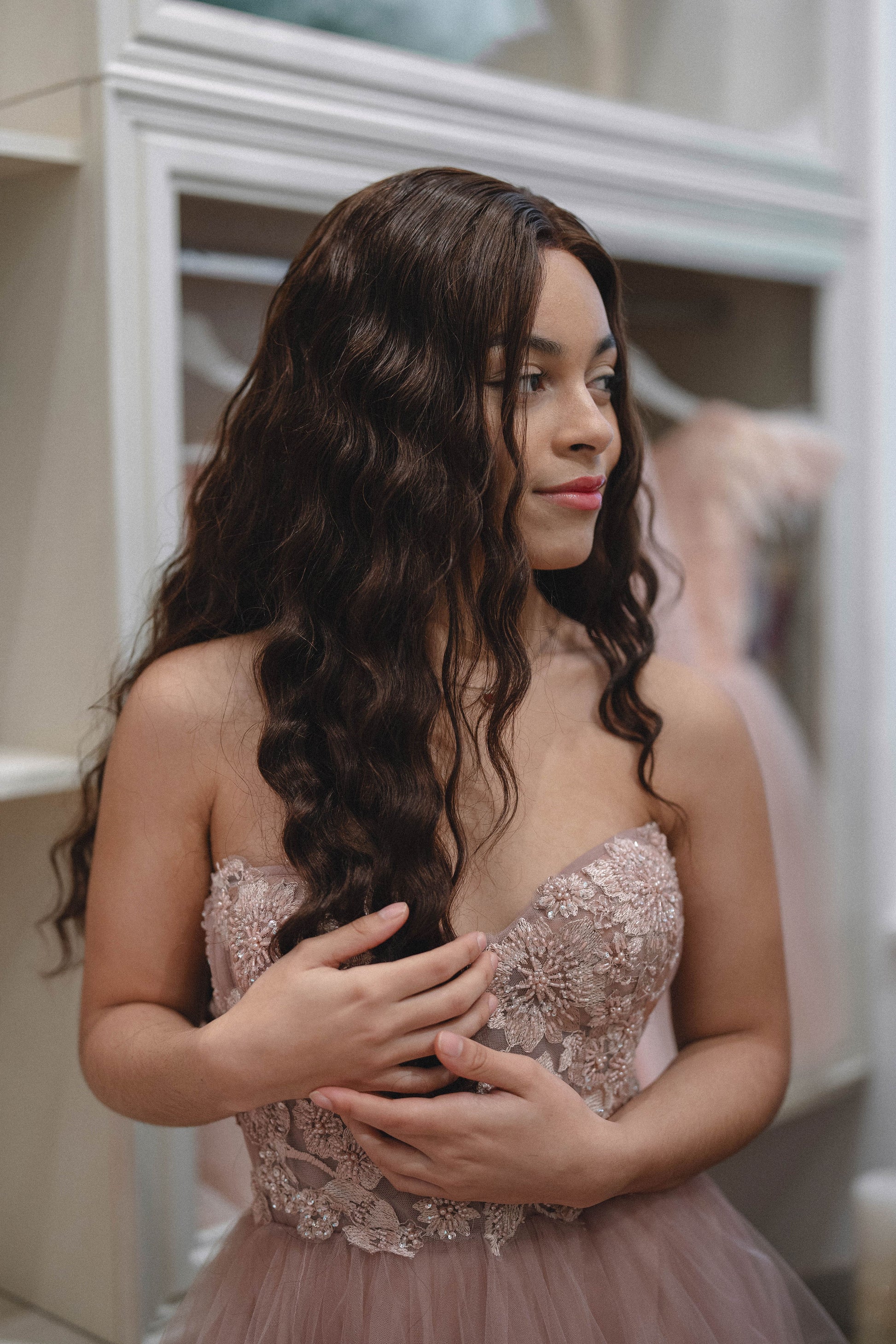 Woman wearing Célia wig made from 100% human hair, designed for a sleek, elegant look with a natural appearance and smooth texture. Available in multiple colors for a customized style.