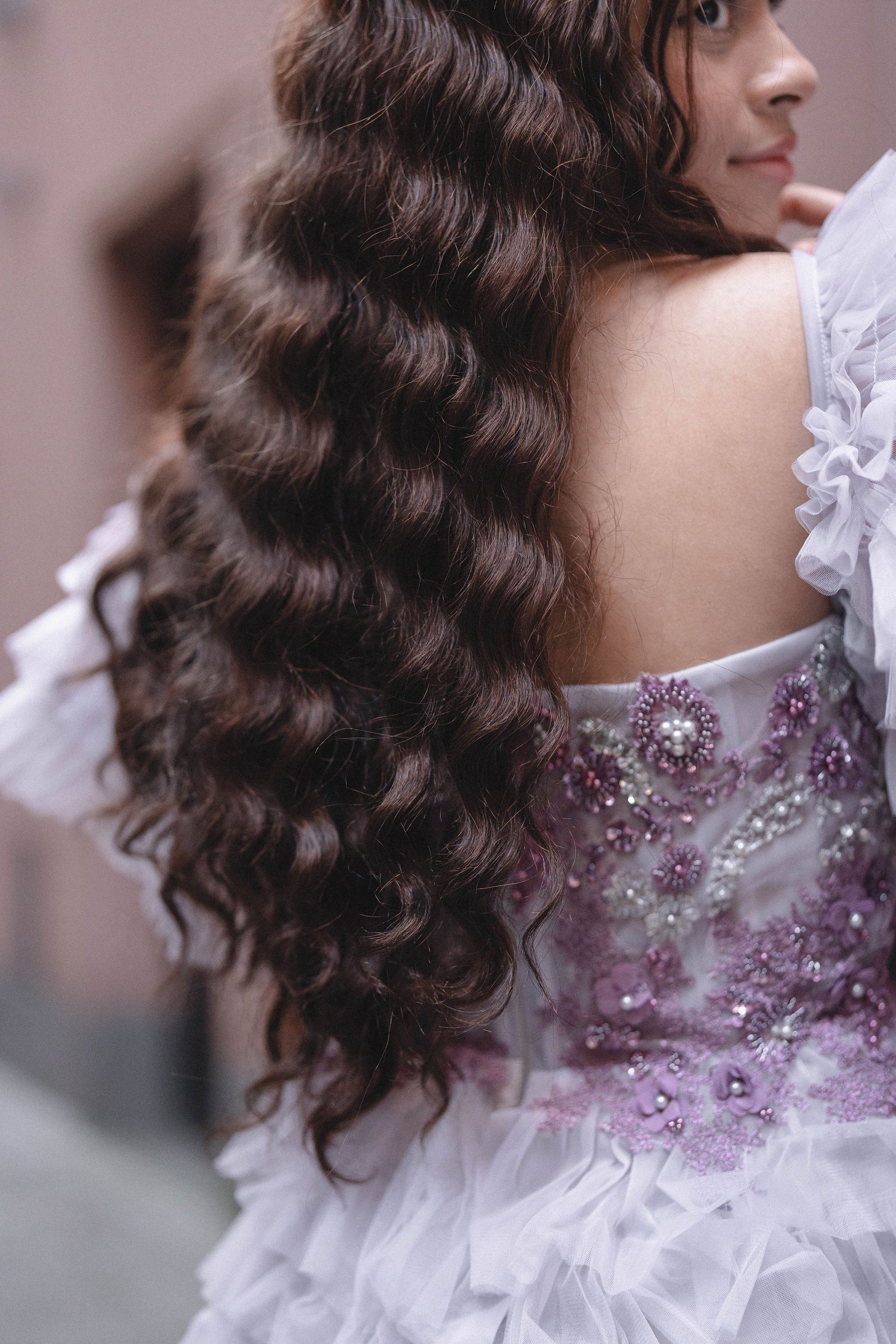 Woman wearing Célia wig made from 100% human hair, designed for a sleek, elegant look with a natural appearance and smooth texture. Available in multiple colors for a customized style.