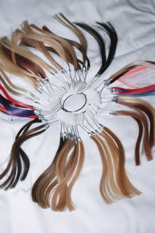 Color ring showcasing vibrant hair extensions made from 100% human hair sourced from Vietnam, offering a variety of shades for customizable styles.